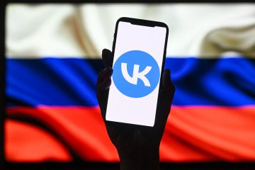 EU Imposes Sanctions on Tech Giant VK and State-Backed MAX Messaging App This illustration photograph shows the logo of Russian social media platform VK displayed on a smartphone in Moscow on June 25, 2026. (Source: Getty Images)