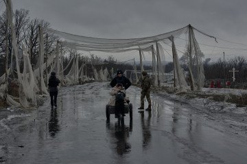 Civilians evacuate Kostyantynivka beneath protective anti-drone nets in Ukraine’s Donetsk region on February 13, 2026. (Source: Getty Images)
