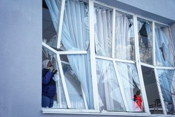 Workers dismantle windows of a school cafeteria, broken following a Russian drone strike on a nearby residential building on February 3, 2026, in Kyiv, Ukraine. (Source: Getty Images)