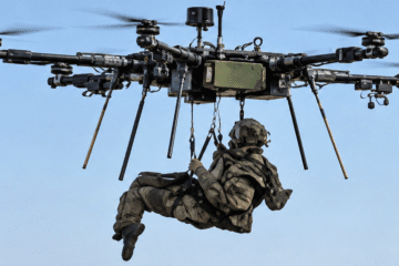An illustrative image shows a Ukrainian soldier suspended beneath a heavy hexacopter during a rehearsal of an aerial evacuation. (Source: Bairak Oleh via Facebook)