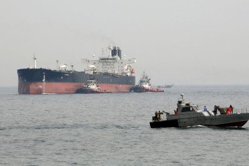 An Iranian military speedboat patrols the waters as a tanker perpares to dock at the oil facility in the Khark Island, on the shore of the Gulf. (Source: Getty Images)