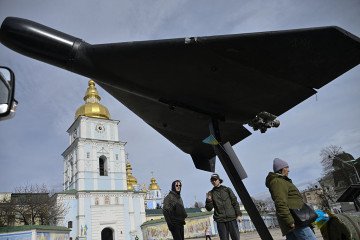 People look at an Iranian-designed HESA Shahed 136 (Geran-2) drone at an open-air exhibition of destroyed Russian military equipment on Mykhailivska Square in front of Saint Michael’s Golden-Domed Cathedral, in Kyiv, Ukraine. (Source: Getty Images)