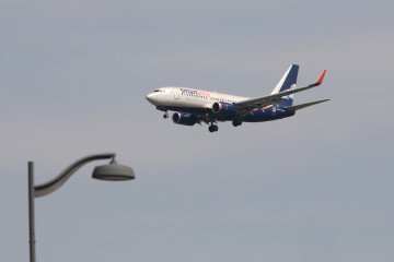 Russian Aviation Faces New International Route Cuts Amid Sanctions and Drone Threats A Boeing 737-752 aircraft of Smart Avia airlines is seen in the sky above Pulkovo Airport. Illustrative photo. (Source: Getty Images)