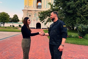 Laura Loomer shakes hands with Ukraine’s acting Defense Minister Yevheniy Khmara outside St. Sophia Cathedral in Kyiv. (Source: X / Laura Loomer)