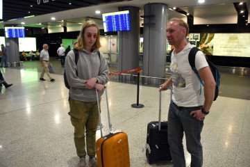 Russian nationals with luggage at Zvartnots International Airport in Yerevan, Armenia, amid increased arrivals from Russia. Russian nationals with luggage at Zvartnots International Airport in Yerevan, Armenia, amid increased arrivals from Russia.