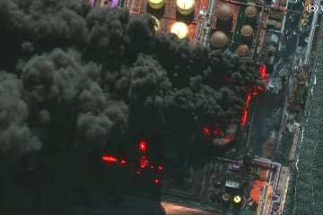 Satellite image shows multiple oil storage tanks on fire with thick black smoke billowing from the Russian Ust-Luga oil terminal complex after multiple drone strikes. (Source: Satellite image (c) 2026 Vantor via Getty Images)