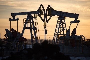 Oil pumping jacks, also known as “nodding donkeys”, operate in an oilfield near Almetyevsk, Tatarstan, Russia, on March 11, 2020.