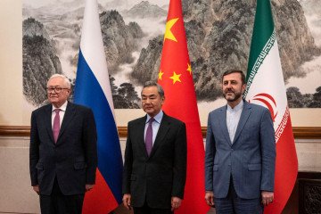 Russia’s Deputy Foreign Minister Sergey Ryabkov (L), China’s Foreign Minister Wang Yi (C) and Iran’s Deputy Foreign Minister Kazeem Gharibabadi during a meeting in Beijing, China. (Source: Getty Images)