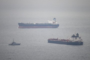 Russian Ships Use First and Second World War Camo and Cages Against Ukrainian Drones A tanker passes a border security vessel and the detained Smyrtos vessel outside the harbour. (Source: Getty Images)