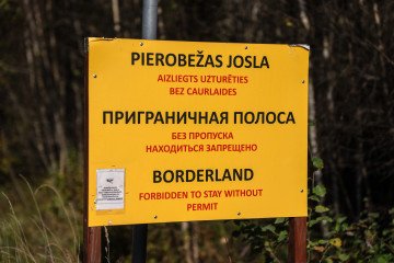 A sign warns people not to proceed along a road near the Latvian border with Russia. (Source: Getty Images)