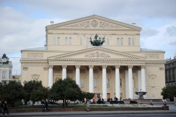 People pass by the Bolshoi Theatre in Moscow, on September 27, 2011. (Source: Getty Images)
