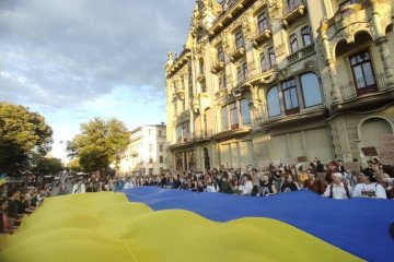 Demonstrators holding a large Ukrainian flag during a rally on July 24, 2026. (Source: Social media)