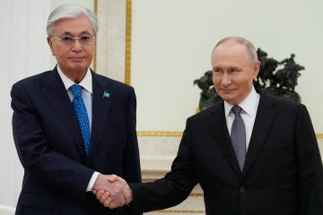 Russian President Vladimir Putin and Kazakh President Kassym-Jomart Tokayev shake hands during their meeting at the Senate Palace of the Kremlin in Moscow on November 11, 2025. (Source: Getty Images)