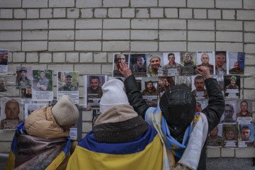Family members hold photos of their captured relatives following a prisoner exchange between Ukraine and Russia on February 5, 2026 in the Chernihiv region of Ukraine. (Source: Getty Images)