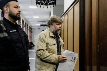 Police officers escort Alexander Butyagin, a Russian archaeologist suspected by Ukraine of unauthorised excavation and plundering of historical artefacts in Crimea, at the District Court in Warsaw, Poland. (Source: Getty Images)