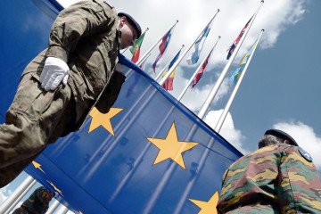 Soldiers of a Eurocorps detachment raise the European Union flag to mark the inaugural European Parliament session. (Source: Getty Images)