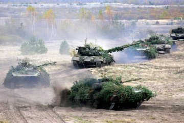 Belarus tanks move along a road during the “Autumn-2008” military drill near the village of Volka, some 150 km outside Minsk, on October 19, 2008.