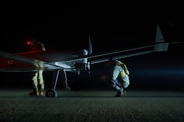 Ukrainian servicemen conduct final checks on a long-range drone before launch during nighttime operations. (Photo: UNITED24 Media)