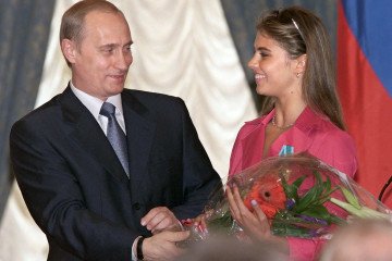 Russian leader Vladimir Putin hands flowers to Alina Kabayeva. (Source: Getty Images)