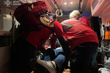 Emergency medics treat a wounded civilian inside an ambulance following a Russian drone strike in Kyiv. (Source: DSNS Kyiv)