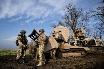Servicemen of the 808th Dniester Separate Support Brigade of the Ukrainian Armed Forces work beside a GCS-200 explosive hazard-clearance machine during demining operations on a liberated territory in Kherson region, Ukraine, (Source: Getty Images)
