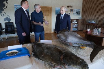 Russia’s President Vladimir Putin visits the Yasny fish processing factory on Iturup island, one of four islands in the contested chain known as the Kuril Islands in Russia and the Northern Territories in Japan, on August 13, 2026.