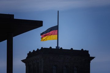 The flag of the Federal Republic of Germany flies at half-mast on the Reichstag building. (Source: Getty Images)