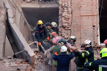 Rescuers evacuate an injured civilian from the rubble of a damaged residential building following a Russian strike in Dnipro, April 25, 2026. (Source: State Emergency Service of Ukraine in Dnipropetrovsk region)