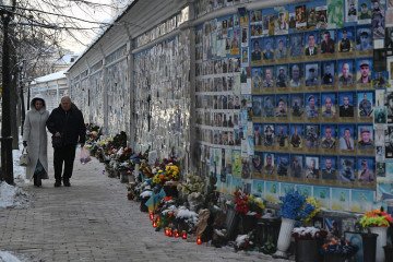 People walk past The Wall of Remembrance of the Fallen for Ukraine, a memorial for Ukrainian soldiers, on a cold winter day in Kyiv on February 2, 2026, amid the Russian invasion of Ukraine. (Source: Getty Images)