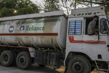 A Reliance Industries Ltd. oil tanker trucks sit parked near Jawaharlal Nehru Port, operated by Jawaharlal Nehru Port Trust (JNPT), in Navi Mumbai, Maharashtra, India, on March 30, 2020. (Source: Getty Images)