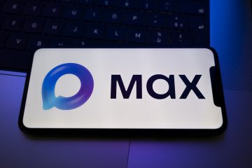 Moscow University Students Pressured to Use State App Max to Receive Diplomas The Max logo appears on a smartphone screen placed on a laptop keyboard illuminated by purple light in Creteil, France, on February 16, 2026. Illustrative photo. (Source: Getty Images)