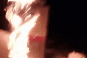 A fire engulfs a target, likely a piece of military equipment or infrastructure, in a night operation. (Source: ATESH)