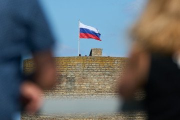 The Russian flag is seen flying on the Ivangorod fortress in this file photo taken on 24 July 2024 in Narva, Estonia. (Source: Getty Images)
