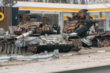Two destroyed Russian tanks marked with the Russian military symbol “V” stand on the scene of hostilities at a damaged gas station on April 6, 2022, in the Kyiv region, Ukraine. (Source: Getty Images)