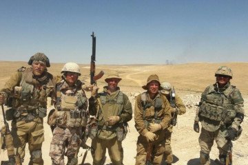 Alleged members of the Wagner Group pose for a photo in a desert landscape, equipped with a mix of Russian and Middle Eastern-style military uniforms. (Source: Russian media) Alleged members of the Wagner Group pose for a photo in a desert landscape, equipped with a mix of Russian and Middle Eastern-style military uniforms. (Source: Russian media)