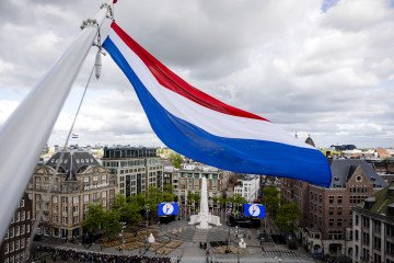 This photograph shows the national flag of the Netherlands flying over Dam Sqaure prior to a National Remembrance Day event, in Amsterdam on May 4, 2025. Illustrative photo. (Source: Getty Images)