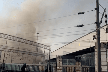 Smoke rises behind an industrial facility, with railway cars in Novorossiysk, Russia. (Source: Ukrainian President Volodymyr Zelenskyy/X)