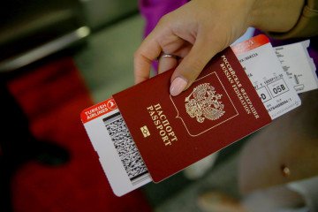 Germany Pushes for Further Cuts to Tourist Visas for Russian Citizens Ticket is seen in a Russian passenger's passport. (Source: Getty Images)