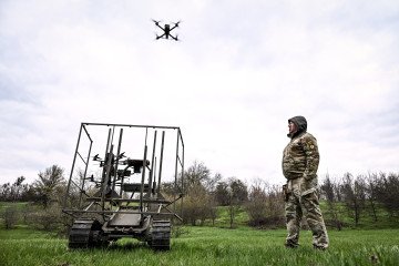 A soldier with the call sign ''Pavuk'' (''Spider'') watches a drone take off from a ground robotic complex during trials at a training ground on April 10, 2026. (Source: Getty Images)