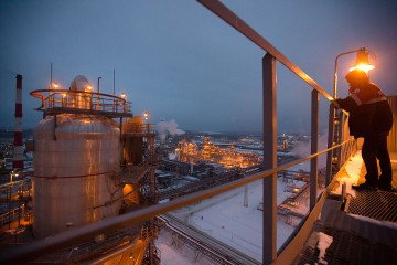 An employee looks out over the illuminated petroleum cracking complex at the Lukoil-Nizhegorodnefteorgsintez oil refinery, operated by OAO Lukoil, in Nizhny Novgorod, Russia. (Source: Getty Images) An employee looks out over the illuminated petroleum cracking complex at the Lukoil-Nizhegorodnefteorgsintez oil refinery, operated by OAO Lukoil, in Nizhny Novgorod, Russia. (Source: Getty Images)