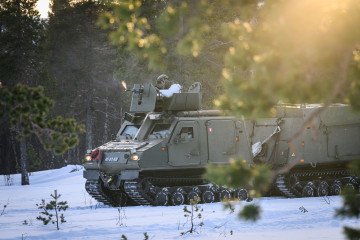 British Royal Marines conduct Arctic warfare drills with BvS 10 all-terrain vehicles during cold‑weather training in northern Norway, as NATO allies expand military cooperation in the High North. (Photo: Getty Images)