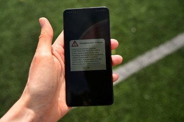 A person holds a phone displaying a possible air raid warning in Vilnius, Lithuania, on June 13, 2026. (Source: Getty Images)