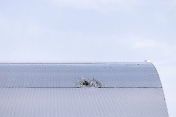 Damaged New Safe Confinement over Reactor 4 at the Chornobyl Nuclear Power Plant following a Russian drone strike. (Source: Getty Images)