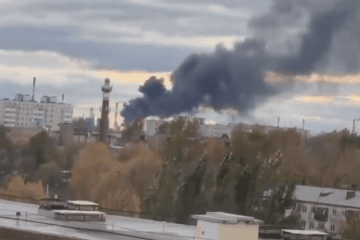 Thick black smoke rises over an industrial area in Omsk, Russia, following a reported Ukrainian drone strike on the Omsk Oil Refinery on October 8, 2026. (Source: Exilenova+)