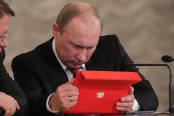 Russian leader Vladimir Putin holds an Apple iPad during the all-Russia congress of judges on December 18, 2012, in Moscow, Russia. Russian leader Vladimir Putin holds an Apple iPad during the all-Russia congress of judges on December 18, 2012, in Moscow, Russia.