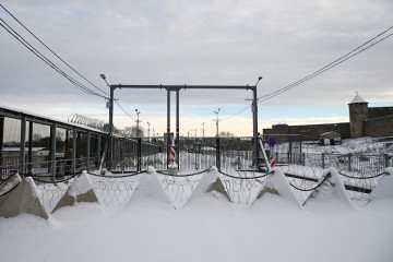 Anti-tank barriers known as “dragon’s teeth” and barbed wire are installed on the border bridge in Narva on the Estonian-Russian border on January 15, 2026. (Source:  Getty Images)