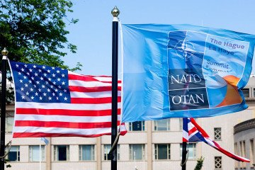 A US and a NATO flag flutter in the wind ahead of a NATO summit in The Hague, on June 23, 2025. (Source: Getty Images)