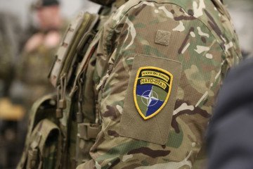 An emblem of the NATO combat unit in Estonia is attached to the uniform of a soldier. (Source: Getty Images)