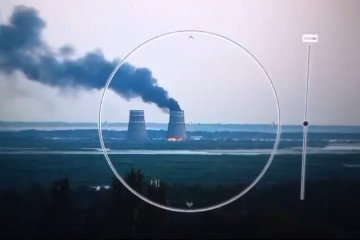 Smoke rises near the Zaporizhzhia Nuclear Power Plant, viewed through an optical device from across the Dnipro River. (Source: UNITED24 Media/YouTube)