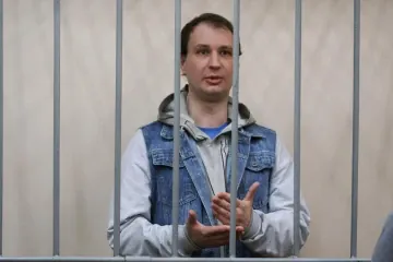 Former US Marine Robert Gilman gestures behind bars inside a Russian courtroom during legal proceedings in Voronezh. (Source: Russian media) Former US Marine Robert Gilman gestures behind bars inside a Russian courtroom during legal proceedings in Voronezh. (Source: Russian media)